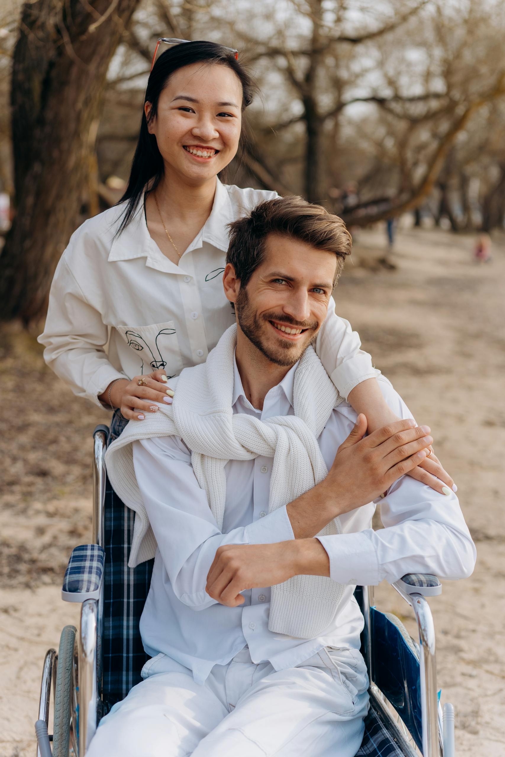Couple smiling together at the beach, showcasing love and accessibility.